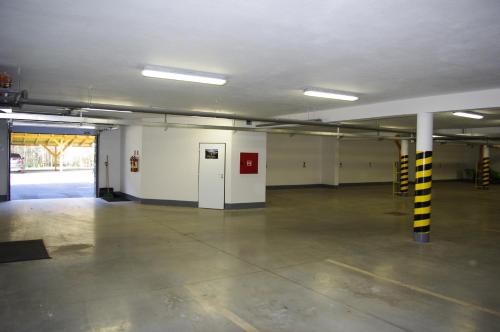 an empty parking garage with a parking lot at Apartmán KLAUDIA Tále in Tale
