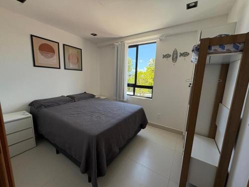 a bedroom with a bed and a window at 105 Dutra Ocean Flat - Take Home in Tambaú