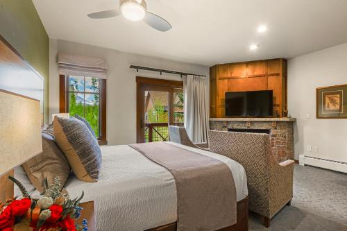 a bedroom with a large bed and a fireplace at Hyatt Main Street Station Studio in Breckenridge