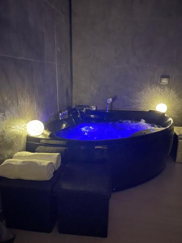 a blue tub in a bathroom with two towels at Artemide Resort Spa - Private Villa & Spa Suites in Lido Di Fondi