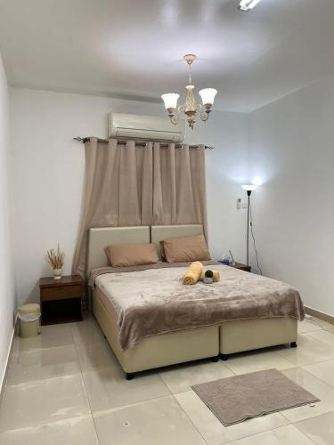 a bedroom with a bed with a stuffed animal on it at Royale Rooms in Al Ain