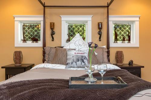 a bed with a tray with wine glasses on it at Shawnigan Suite B & B in Shawnigan Lake