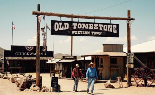 two men are standing in front of a sign at Tombstone History & Cozy Cabin Glamping Stay in Tombstone