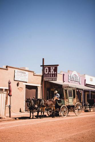 a horse drawn carriage on the side of a street at Cozy Old West Glamping Walk to Tombstone in Tombstone