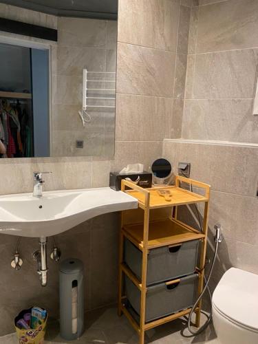 a bathroom with a sink and a toilet and a mirror at eliamaria domus artificis in Lefkada Town