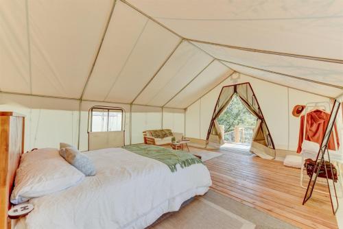 a bedroom with a bed in a tent at Hill Country Escape Glamping Tent in Boerne