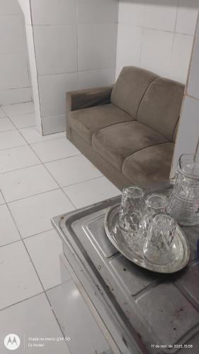 a living room with a couch and a table with glasses on it at Casa Completa 2 Santa Alexandrina in Rio de Janeiro