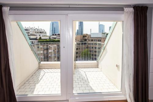 a window with a view of the city at Canova Hotel in Milan