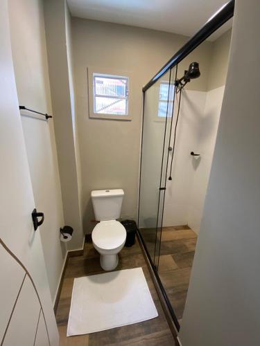 a bathroom with a toilet and a shower stall at Smart Malls Flats in Belém