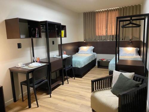 a hotel room with a bed and a desk at Smart Malls Flats in Belém
