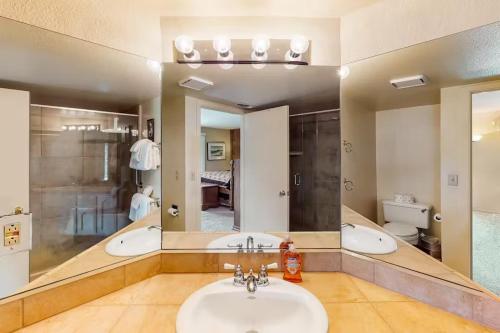 a bathroom with a sink and a large mirror at Eagle's Nest in Big Creek