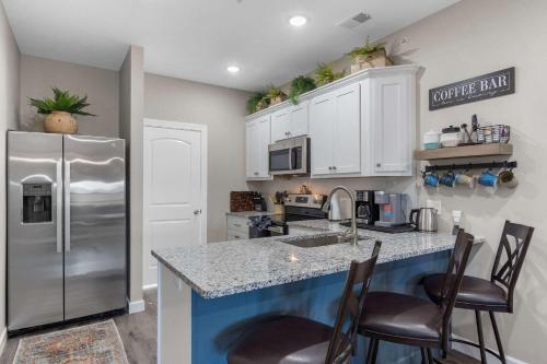 a kitchen with a refrigerator and a counter top at Crossroads Vistas - 3BDR Condo in Branson