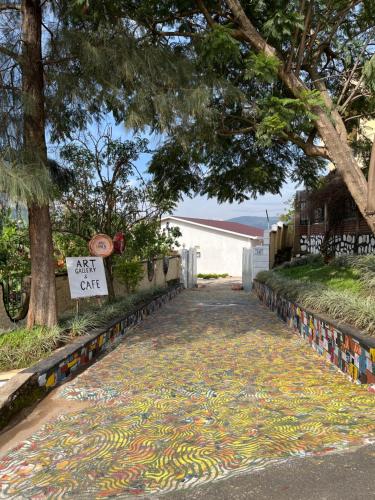 a street with a painting on the sidewalk at Kalpho Art Center in Kigali