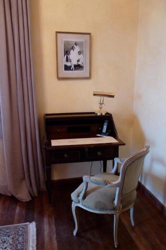 a chair sitting in front of a desk with a piano at Lokanga Boutique Hotel in Antananarivo