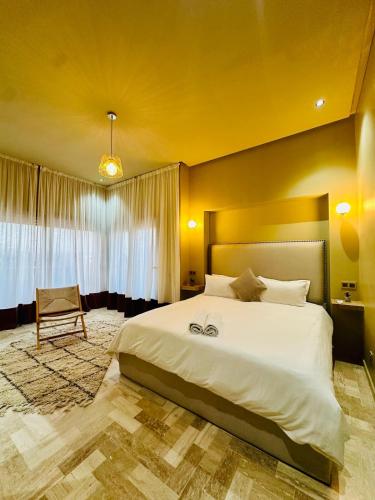 a bedroom with a large white bed in a room at Exceptional Marrakech Villa 5 Bedrooms & Pool in Oulad Akkou