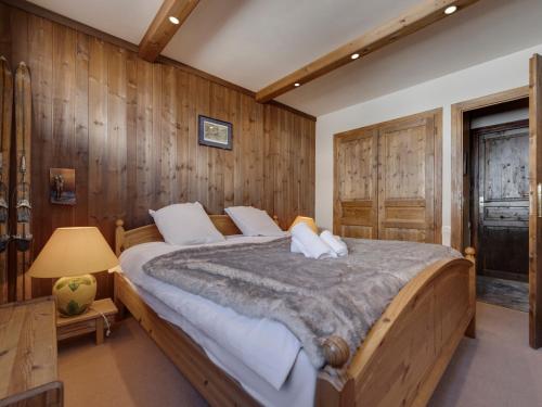 a bedroom with a large bed with wooden walls at Appartement 6 pers, balcon, wifi à Tignes - FR-1-502-583 in Tignes