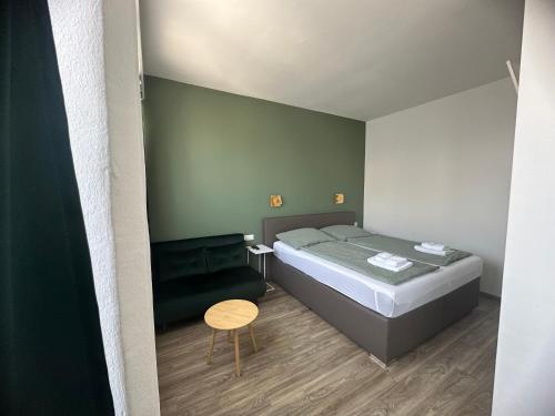 a small bedroom with a bed and a chair at bookVienna "Paula" Apartments in Vienna