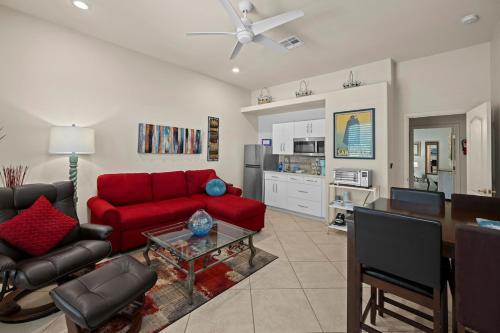 a living room with a red couch and a table at Your Cozy Place in Scottsdale