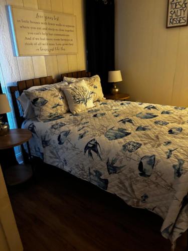 a bed with a comforter and pillows on it at The Cozy Jamozy in Panama City Beach