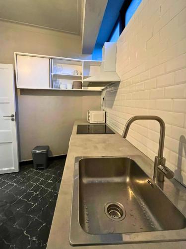 a kitchen with a sink and a counter top at Good end Oporto View in Porto