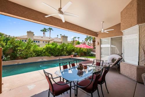 a patio with a table and chairs and a pool at Your Cozy Place in Scottsdale
