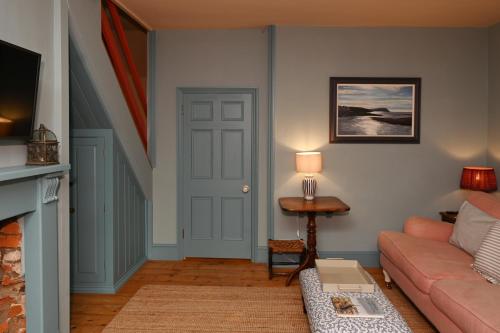 a living room with a couch and a table at Pilots House Aldeburgh in Aldeburgh