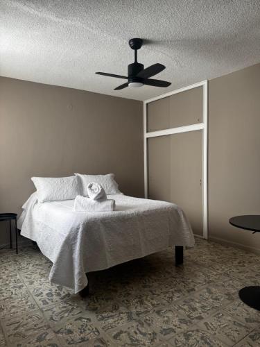 a bedroom with a bed with a ceiling fan at CASA UMBRAL - Plaza principal in Lagos de Moreno