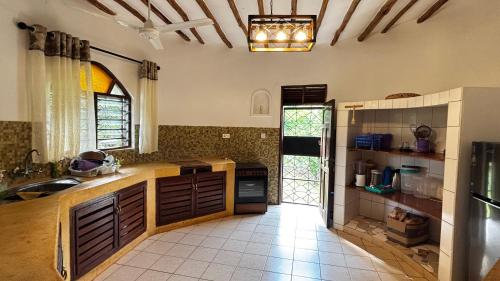 a kitchen with a sink and a counter top at Cozy 1-BR Garden Cottage near Diani Beach in Galu