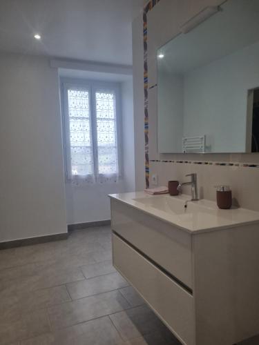 a bathroom with a sink and a mirror at Bel appartement de plein pied avec jardin privé in Moncayolle-Larrory-Mendibieu