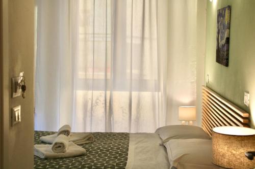 a bedroom with a bed with towels on it at My Bnb Pisa in Pisa