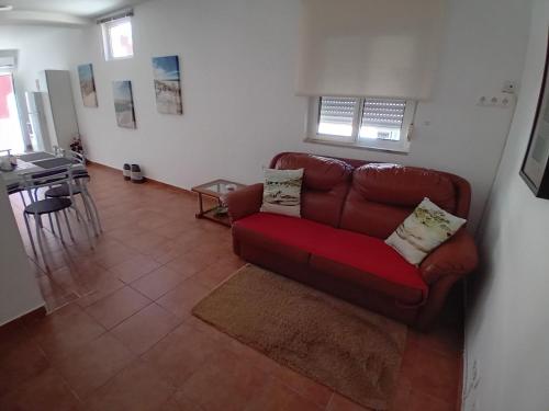 a living room with a red couch and a table at Sweet Sleep Apartment in Lisbon
