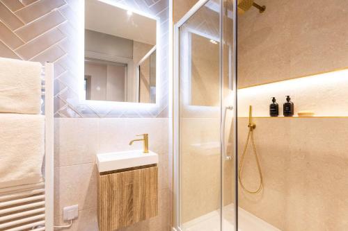 a bathroom with a shower and a sink and a mirror at Apartment Nine Pelican House in Bournemouth