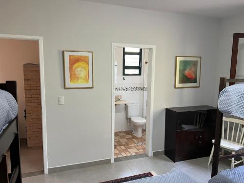 a room with a bathroom with a toilet and a sink at Casa Aquarius in Camanducaia