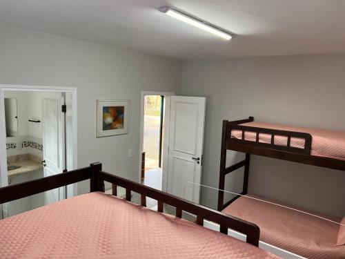 a bedroom with a bunk bed and a staircase at Casa Aquarius in Camanducaia