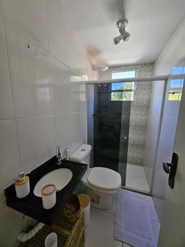 a bathroom with a shower and a toilet and a sink at Villa Sol hospedaria in Paty do Alferes