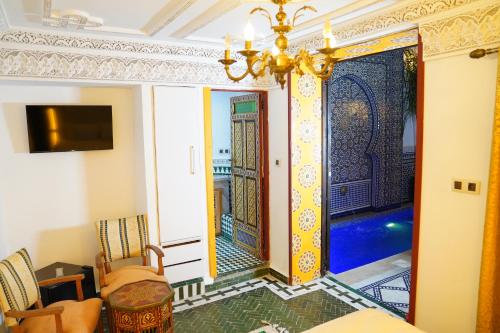 a living room with a door to a pool at Riad Dar El bellar in Fès