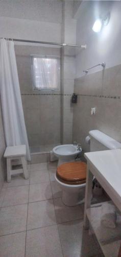 a bathroom with a toilet and a sink at Aguaribay pinamar in Pinamar