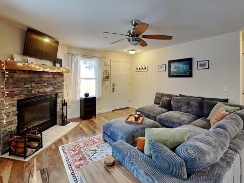 a living room with a couch and a fireplace at The Hideaway House in Swanton