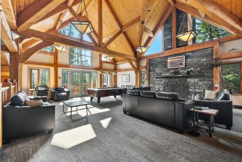 a large living room with a stone wall at HI Lake Louise Alpine Centre - Hostel in Lake Louise