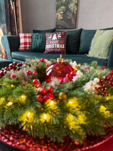 a living room with a christmas tree on a table at VOK Luxury Home I Tropical Living in Arad