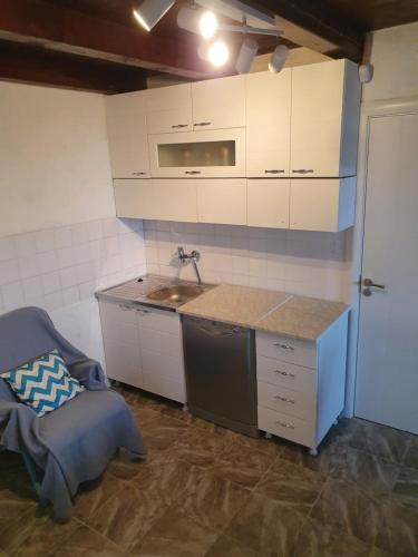 a kitchen with a sink and a counter top at Pure nature lovely view house in Zaklopača