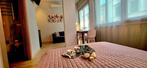 a bedroom with a bed with two teddy bears on it at SeaDoor in Livorno