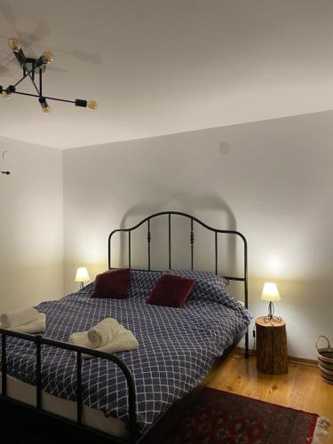 a bedroom with a bed with two pillows on it at Kućice za odmor Šalatin jarek - Free tickets to local attractions in Ðurđevac
