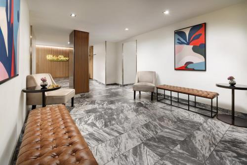 a lobby with a waiting room with a couch and chairs at The Shoreham in New York