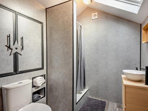 a bathroom with a toilet and a sink at 1 Bed in Dearham 96373 in Dearham