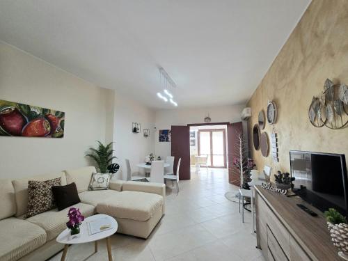 a living room with a couch and a tv at CJ SEA HOME CAMERE in Trapani