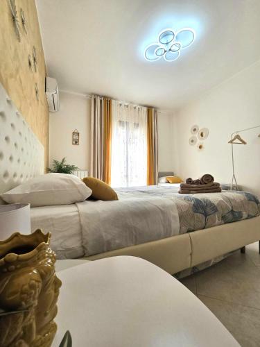 a bedroom with a large bed with a light on the ceiling at CJ SEA HOME CAMERE in Trapani