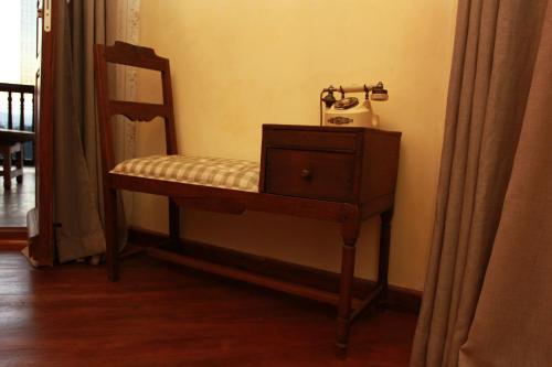 a chair with a telephone on it in a room at Lokanga Boutique Hotel in Antananarivo