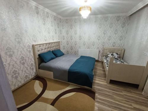 a bedroom with a bed and a crib in it at Nakhchivan Family Home in Naxçıvan