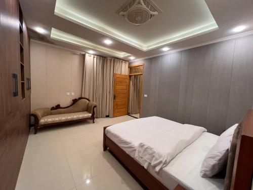 a bedroom with a bed and a couch in it at Cedar hills in Murree